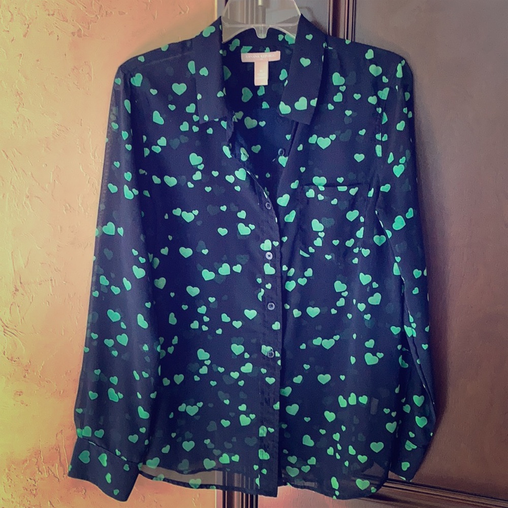 A heart dotted see through button down shirt